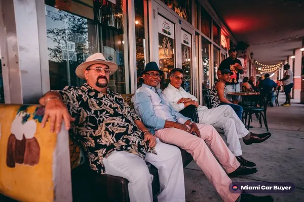 Colorful street in a Miami neighborhood like Little Havana or Hialeah, grounding customer reviews geographically